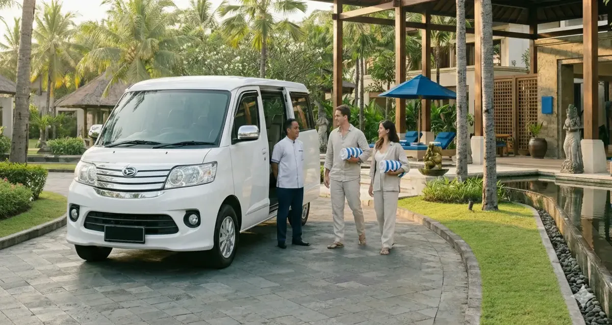 Silver Daihatsu Luxio hotel shuttle picking up guests at a tropical Balinese resort for Nusa Dua Spa free hotel pickup service.