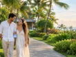 Honeymoon couple walking along a tropical resort garden path in Nusa Dua.