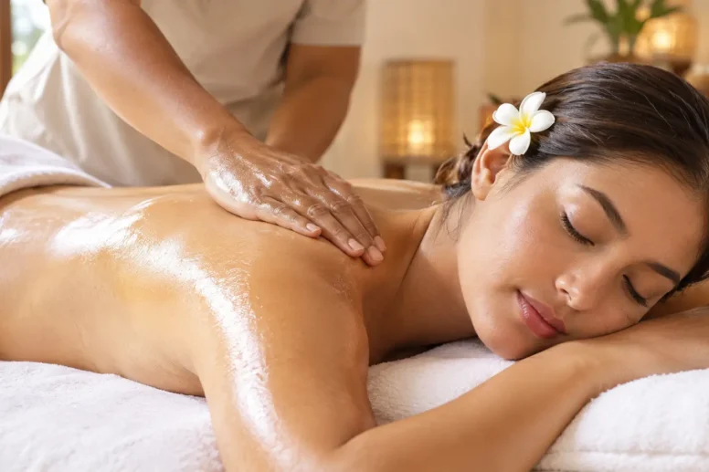 Woman relaxing face down during a Balinese massage, therapist using flat palm pressure on her upper back