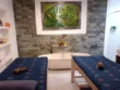 Private couple treatment room with two massage beds and a stone bathtub